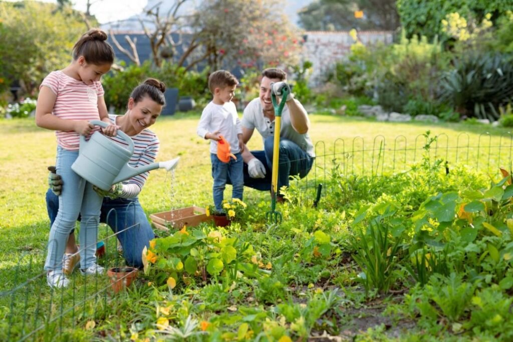 happy caucasian family gardening and watering plants together e1665071317426